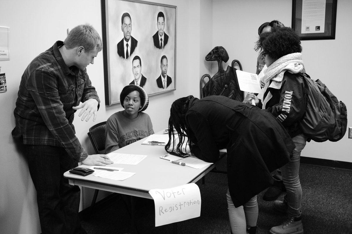 Maryam "MJ" Robinson, a junior majoirng in political science, assists students in registering to vote at "Barack to the Future," an event organized by the Society of African American Culture that took place in Witherspoon Student Center on Thursday, Feb. 18th.  Robinson, though a member of SAAC, was volunteering to help with voter registration through the North Carolina Public Interest Research Group, an organization committed to is todelivering public interest policy geared toward the people.