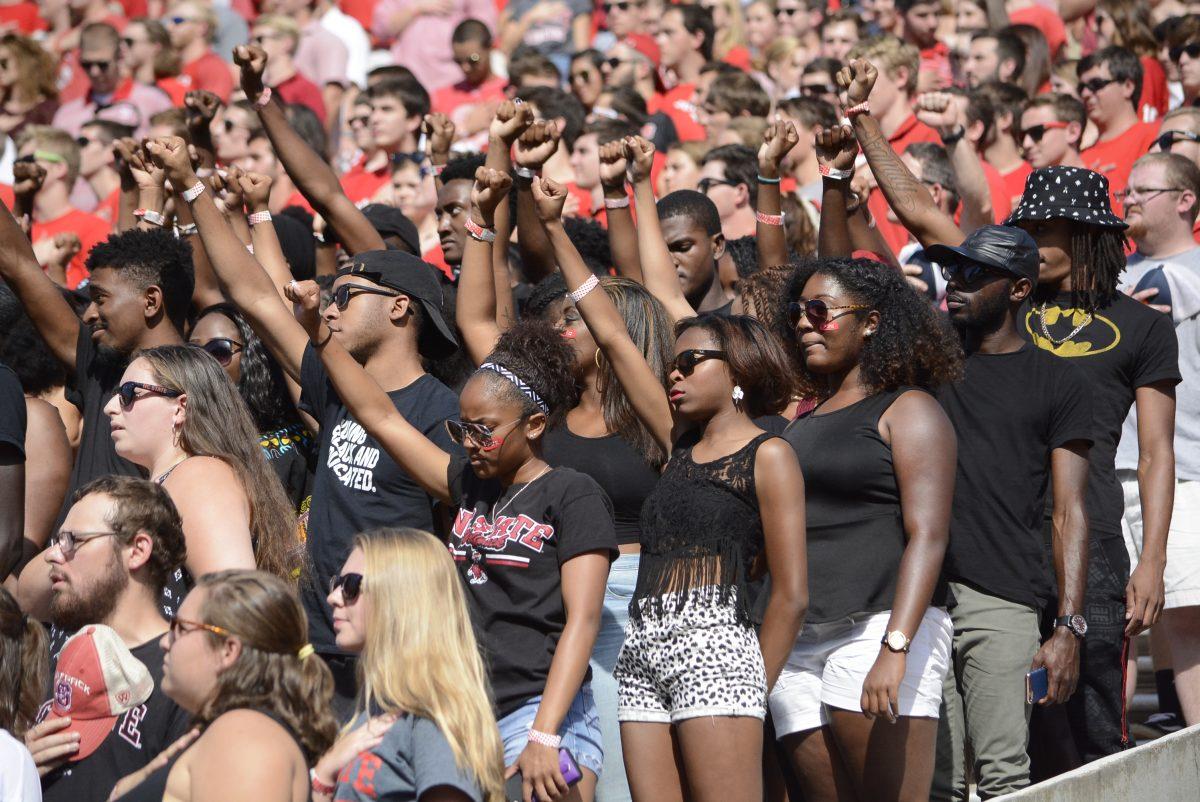 Wolfpack members raise their fists as a display against the systemic racism, according to their Facebook event page, during the game against Wake Forest in Carter-Finley Stadium on Oct. 1. The Wolfpack beat the Demon Deacons, 33-16, delivering the first loss of Wake Forest's season.