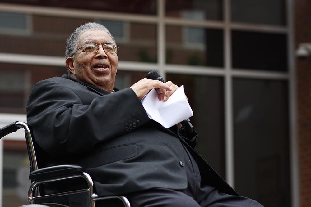 Irwin Holmes rips up his speech to address the crowd at the Holmes Hall dedication on Nov 1. 2018. The building was named after Irwin Holmes to honor him and his accomplishments. (Sarah Trudan/Staff Photographer)