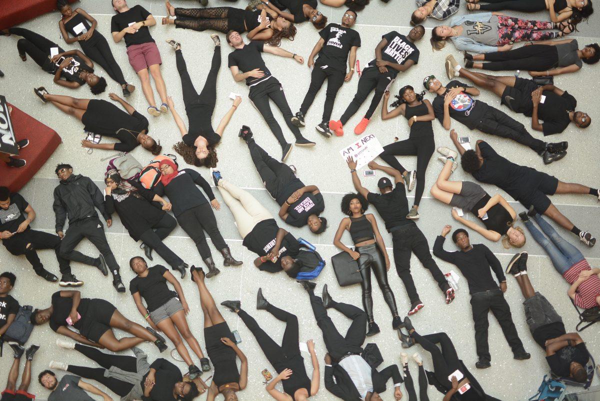 Students fill the floor of the atrium in Talley Student Union as a part of the blackout on Friday, Sept. 23, 2016. The blackout was organized by students and Student Government in response to recent police shootings in Charlotte and Tulsa. After first gathering in Wolf Plaza to listen to speeches from student leaders, students attending the event moved to the atrium of Talley Student Union and occupied the floor as a form of protest in response to recent police shootings in Tulsa and Charlotte for more than half an hour.