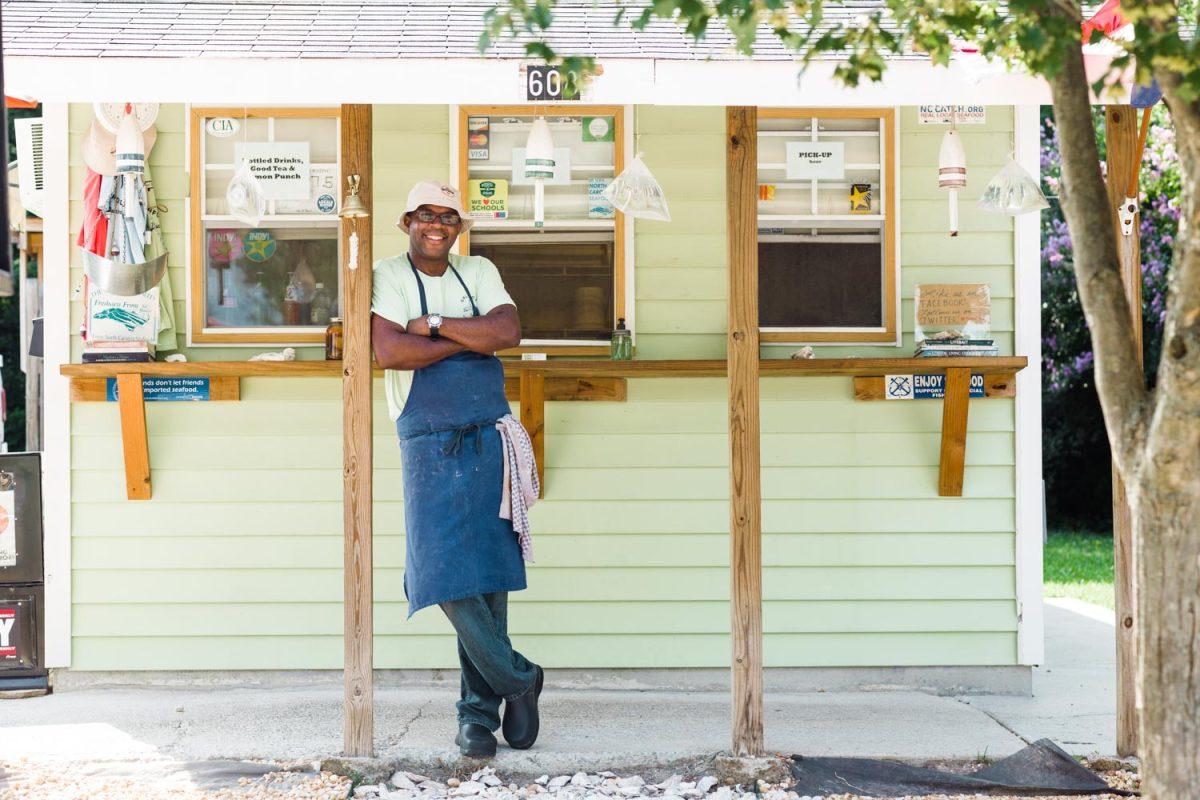 Chef Ricky Moore stands in front Saltbox Seafood.  Photo taken from Saltbox Seafood website. 