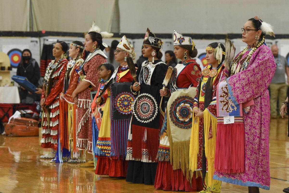 Dancers in the Women's Red Dress Special wait to be judged during the 32nd Annual NC State Powwow in the Carmichael Gymnasium on Saturday, April 1, 2023. The attire worn by the dancers is called Regalia and is often spiritually significant.