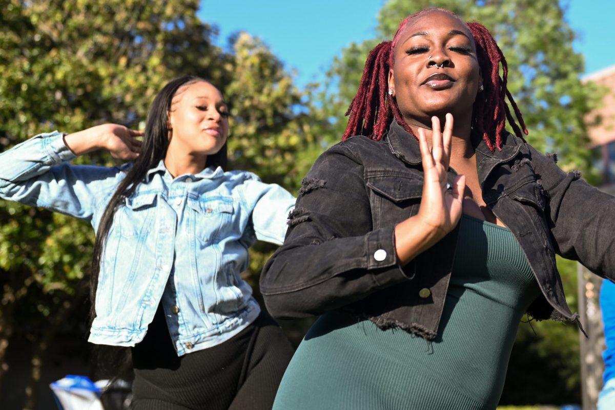 Elantra Yarbor, a fourth-year studying business administration, and Lauren Clark, a fourth-year studying english, dance at the Stomp The Yard Darty at Harris Field on Friday, April 12, 2024. This event featured three different food vendors and a air-brush artist.