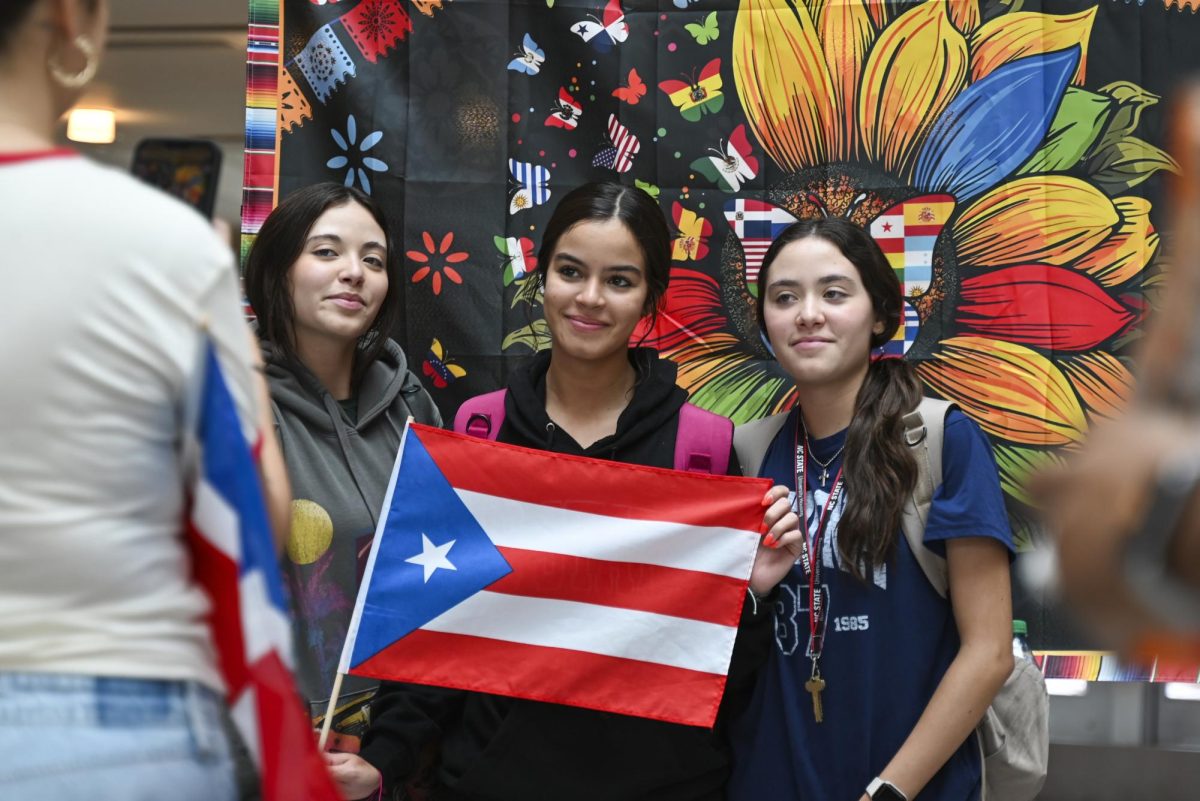 (From left to right) Allison, Kaylee and Natalie Toro, first-years studying biochemistry, pose for a photo during the Latinx Heritage Month Kickoff in Talley Student Union on Friday, Sept. 13, 2024.