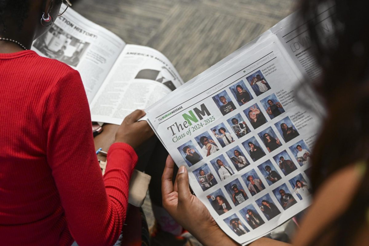 Students read the latest issue of The Nubian Message during The Nubian Message's Launch Party in the African American Cultural Center on Thursday, Sept. 12, 2024. The event celebrated the history of the newspaper and invited students to learn about its founding.