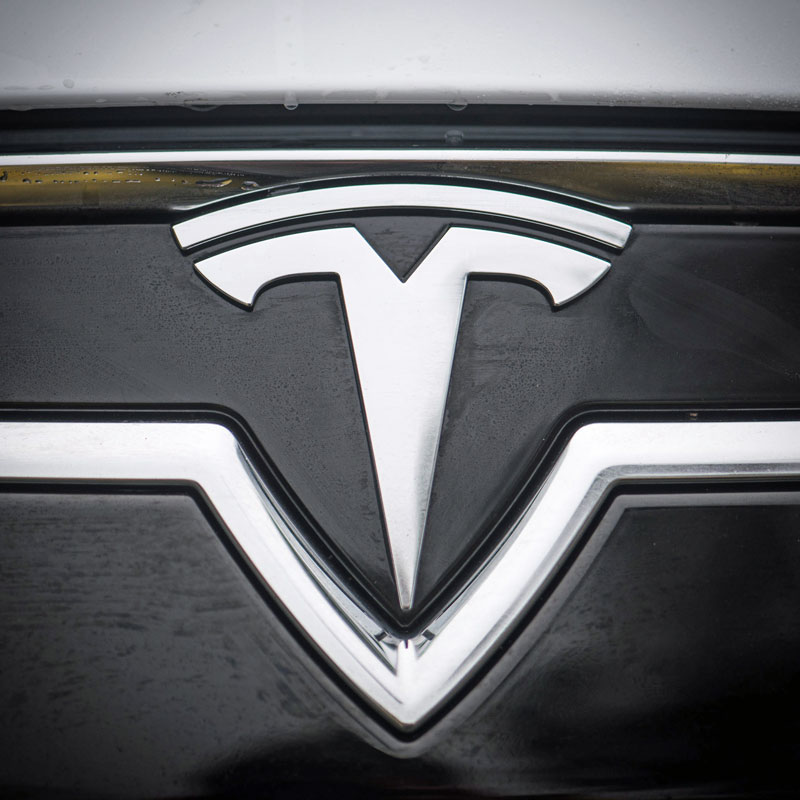 Image of Tesla logo on a car from Creative Commons