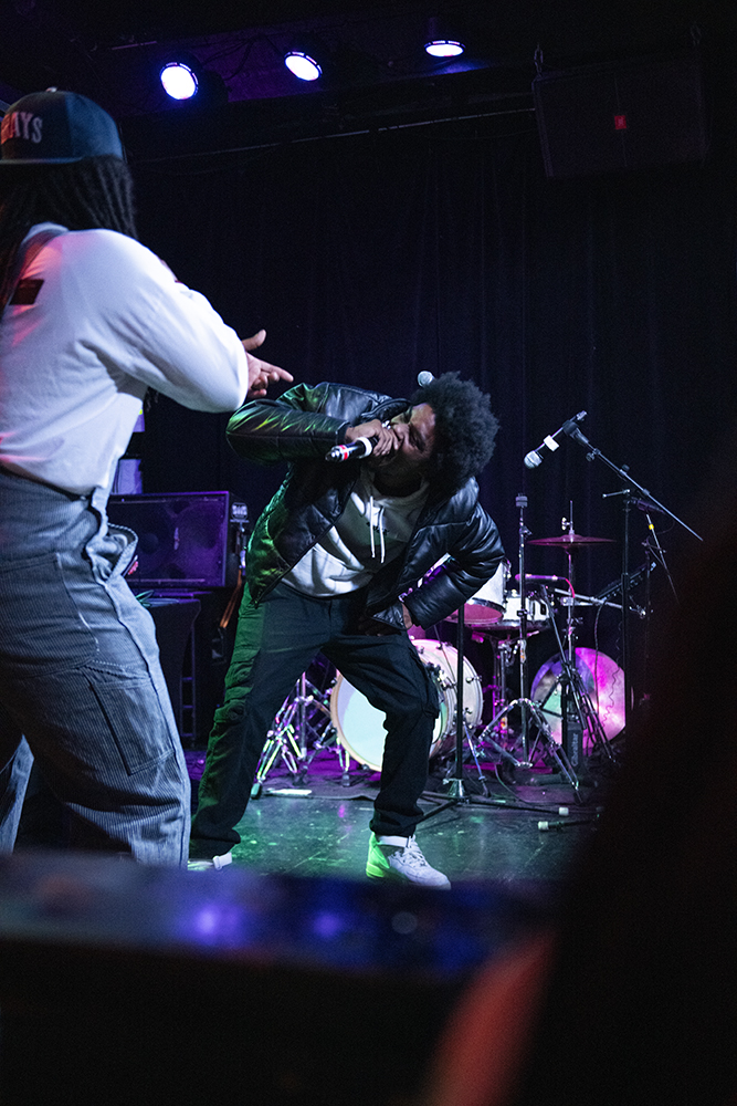 Chalk Martel raps with Yahliq during the House of Art benefit show at The Pour House on Tuesday, Jan. 14, 2025. During his performance Yahliq brought multiple other artists on stage to join him.