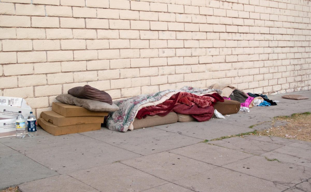 Image of makeshift bed on the sidewalk from Creative Commons