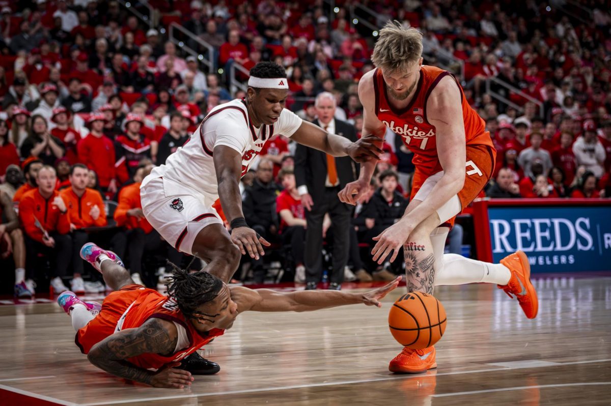 Virginia Tech sophomore guard Ben Hammond and NC State senior forward Ven-Allen Lubin fight for a loose ball during the game in the Lenovo Center on Saturday, Feb. 7, 2026. The Wolfpack defeated the Hokies 82-73.