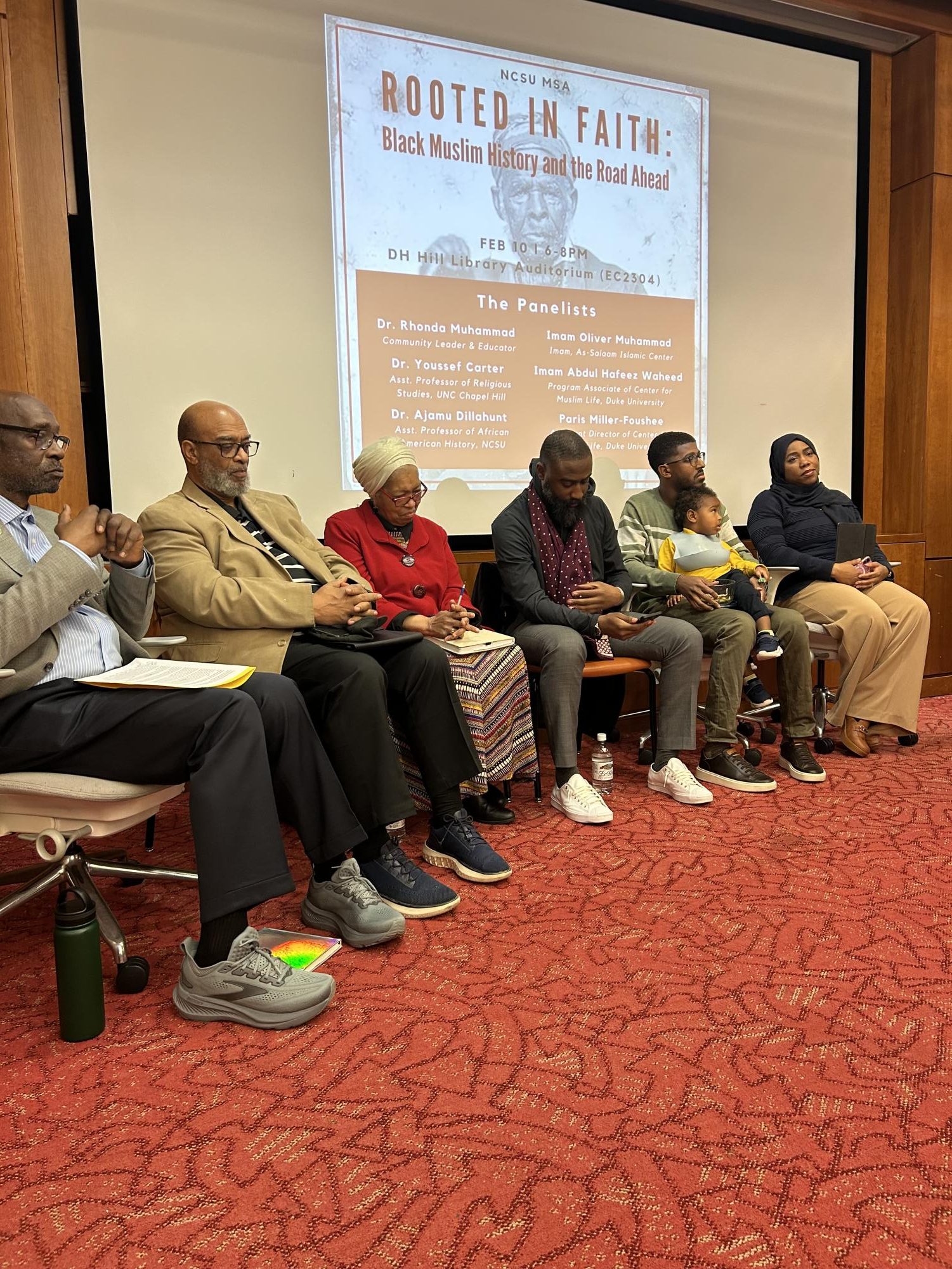 From left to right: Imam Abdul Hafeez Waheed (program associate of Duke Center for Muslim Life), Imam Oliver Muhammad (As-Salaam Islamic Center), Dr. Rhonda Muhammad ( Community leader & Educator), Dr. Youssef Carter (Assistant professor of Religious Studies at UNC Chapel Hill), Dr. Ajamu Dillahunt- Holloway (Assistant professor of African American History, NCSU) holding his son Ajamu, Ms. Paris Miller- Foushee (Assistant Director of Center for Muslim Life, Duke University).