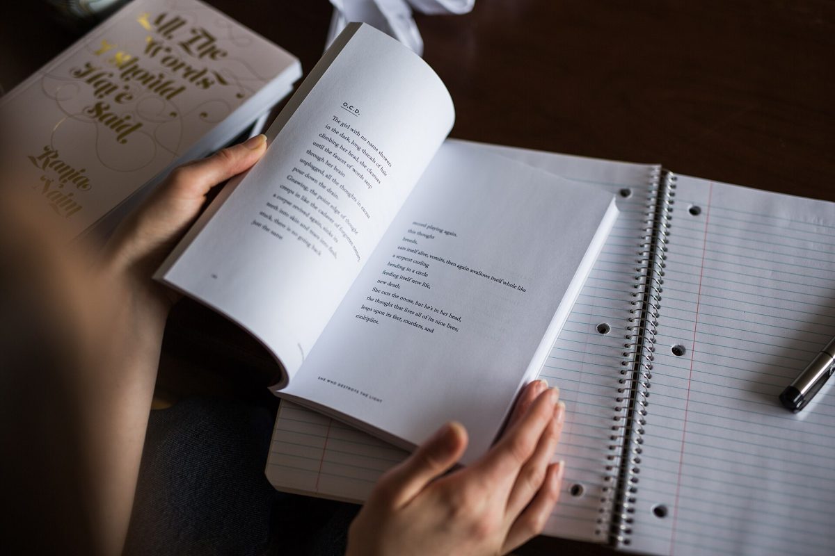 A  young person reading a poetry book